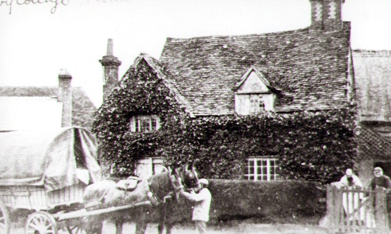 1890s Charles and Phoebe Burton, standing at the gates of Ivy Cottage. Alfred Burton their son is holding the horses.