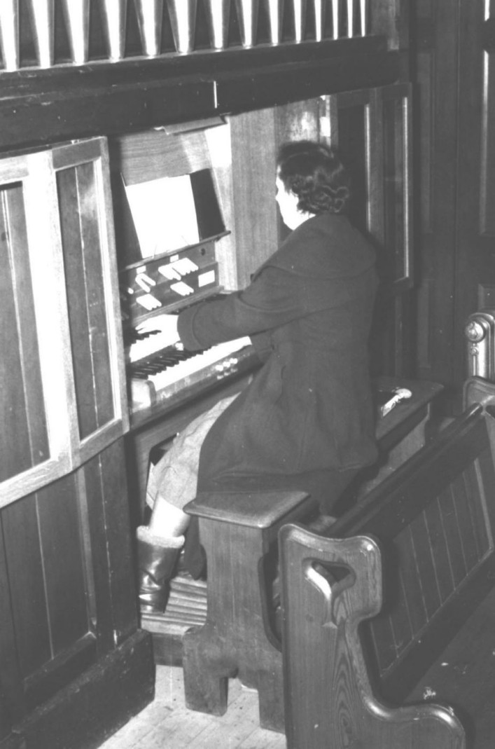 Vera playing the organ at the Methodist church. She has played this organ for 80 years