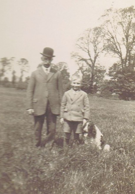 George Weedon and his grandson Bernard Lake.The picture is taken in the middle of the meadow behind 28 and 30 Shillington Road. The tall foreground trees on the right are elms, which died from Dutch Elm Disease in the 1970s. The moderately tall trees beyond them are pear trees in the old Wright’s Farm orchard. The bushes just to the left of George’s right elbow are brambles on the corner of the orchard, where the meadow boundary makes a dog-leg and the culvert under the meadow comes out, wrongly marked as a spring on the Ordnance maps. George Weedon and his grandson Bernard Lake.The picture is taken in the middle of the meadow behind 28 and 30 Shillington Road. The tall foreground trees on the right are elms, which died from Dutch Elm Disease in the 1970s. The moderately tall trees beyond them are pear trees in the old Wright’s Farm orchard. The bushes just to the left of George’s right elbow are brambles on the corner of the orchard, where the meadow boundary makes a dog-leg and the culvert under the meadow comes out, wrongly marked as a spring on the Ordnance maps.